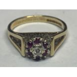 A 9 CARAT GOLD DIAMOND AND RUBY CLUSTER RING SIZE L/M