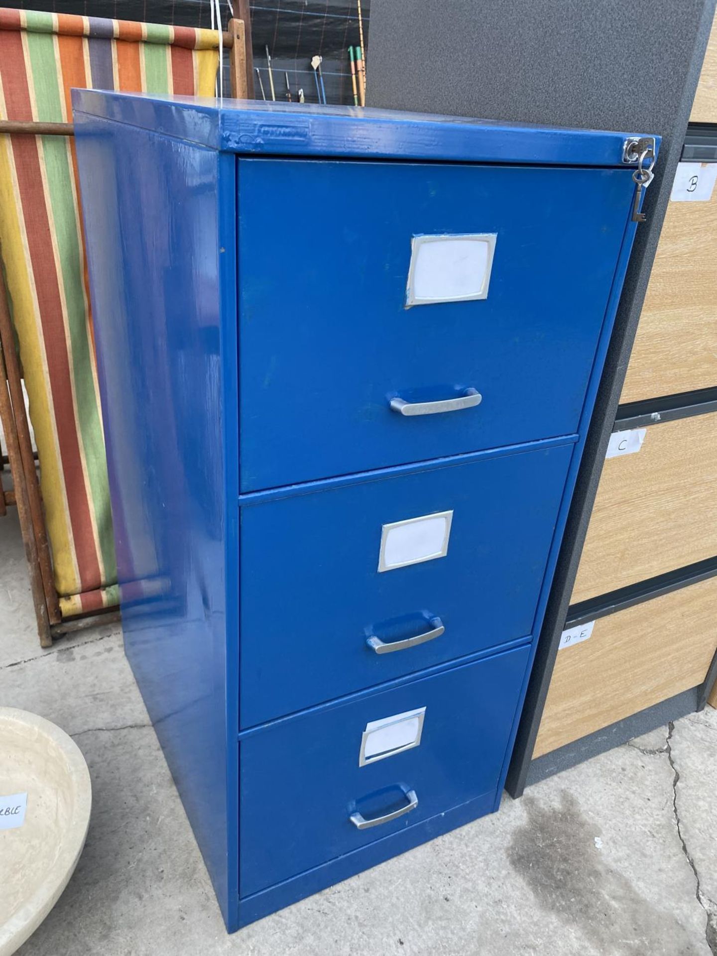 A METAL THREE DRAWER FILING CABINET