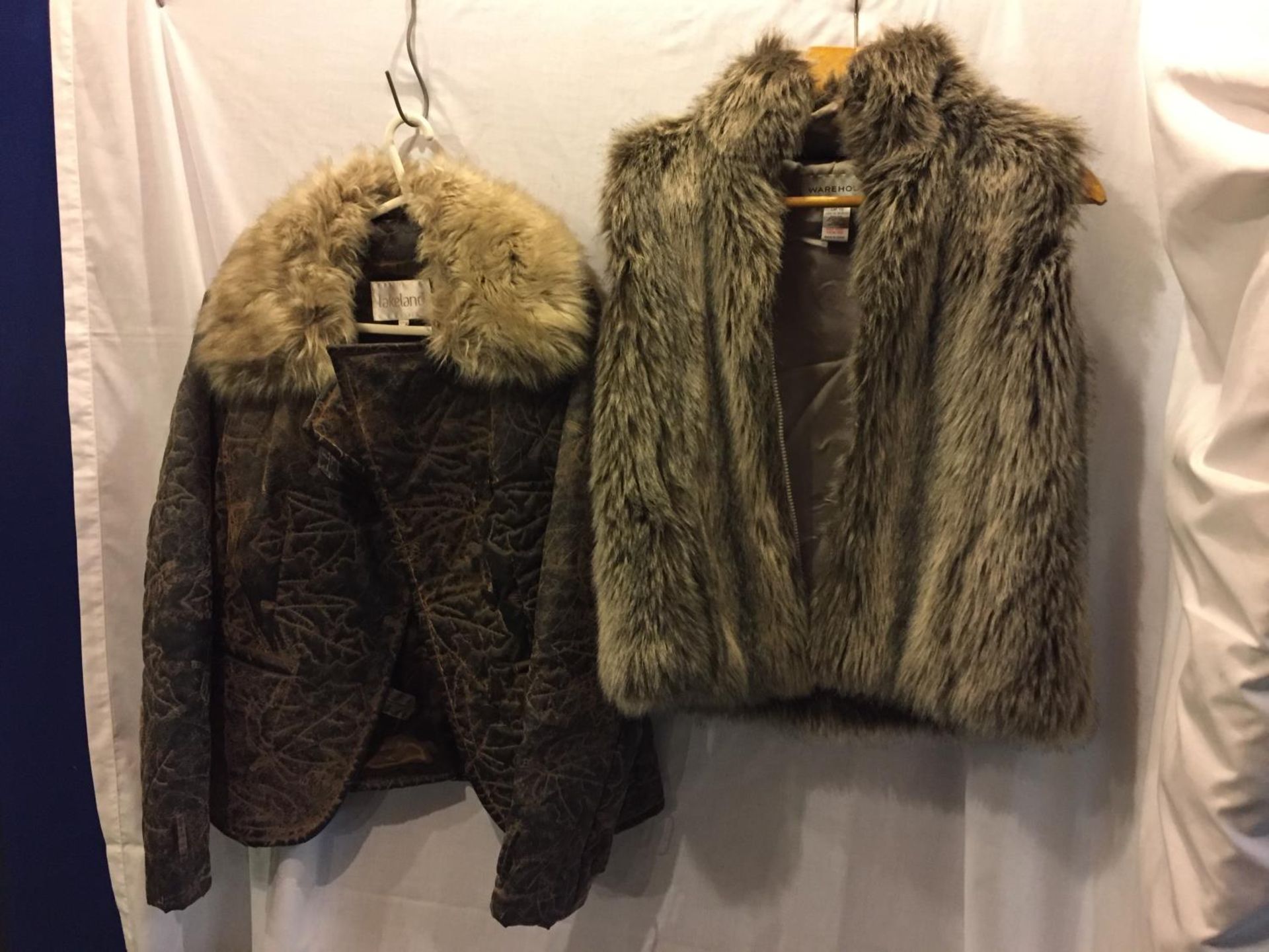 A LADIES LAKELAND COAT SIZE 14 AND A WAREHOUSE FAUX FUR GILET IN A SIZE 16