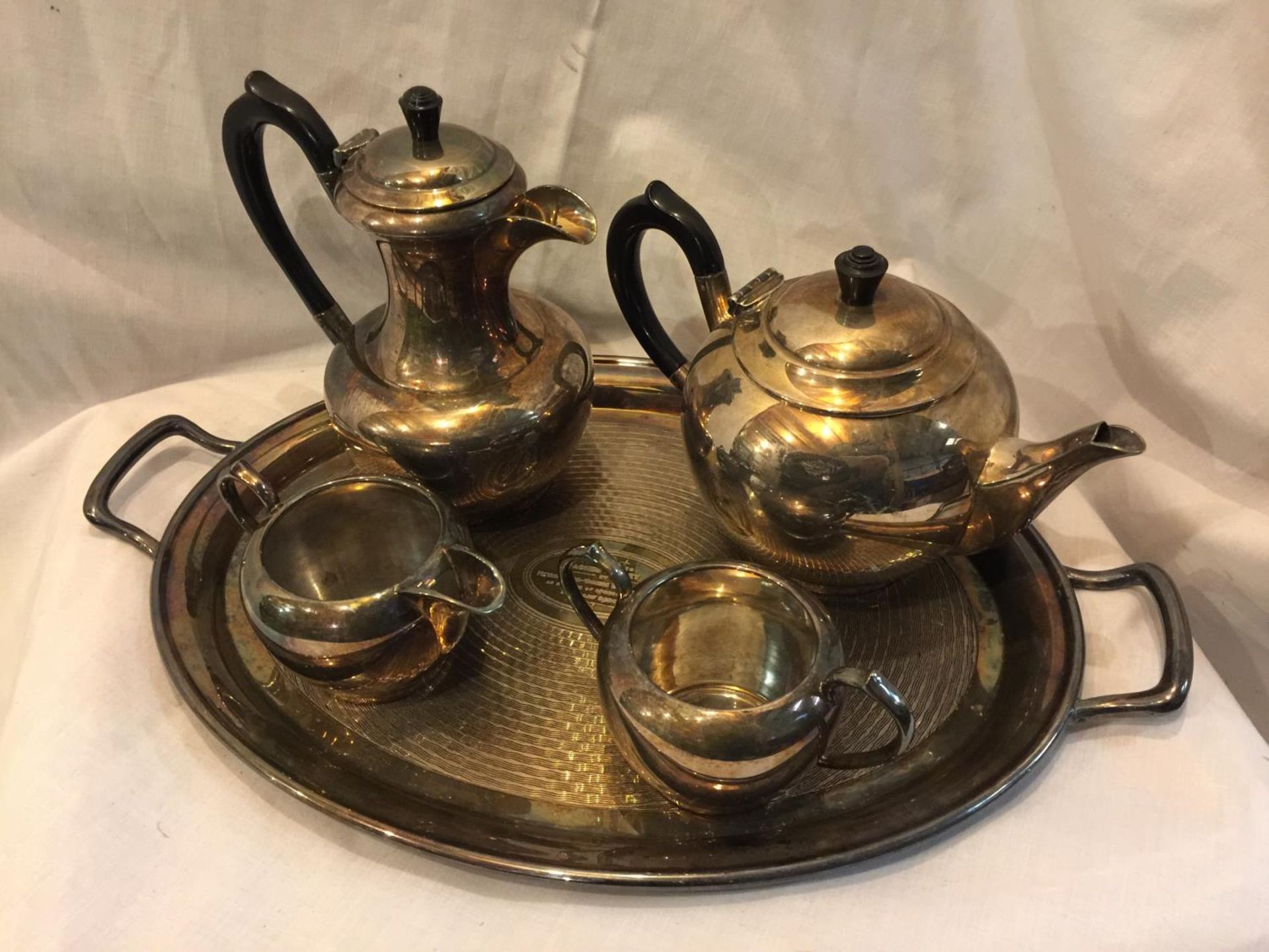 A METAL TEA SET COMPRISING OF A TEAPOT, COFFEE POT, CREAM JUG, SUGAR BOWL AND TRAY