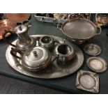 A PEWTER TEASET ON A TRAY, A PLATE ON A STAND AND THREE SMALLER PLATES