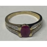 A 9 CARAT GOLD MARKED 375 WITH A CENTRAL PINK STONE AND DIAMOND CHIPS TO THE SHOULDERS SIZE P