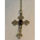 A 9 CARAT GOLD MARKED 375 GOLD CHAIN AND CROSS PENDANT WITH A RED STONE GROSS WEIGHT 1.0 GRAMS IN