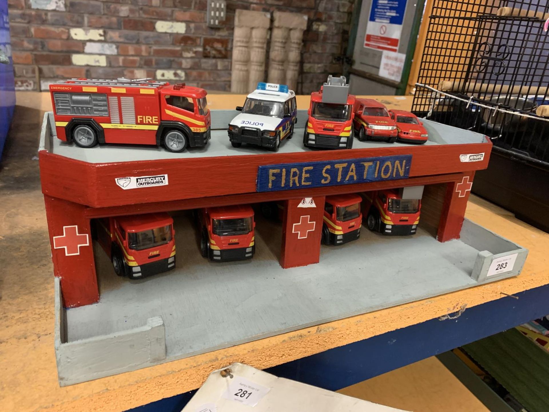 A WOODEN FIRE STATION WITH NINE VEHICLES