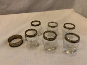 SIX SHOT GLASSES WITH HALLMARKED BIRMINGHAM SILVER RIMS AND A NAPKIN RING