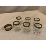 SIX SHOT GLASSES WITH HALLMARKED BIRMINGHAM SILVER RIMS AND A NAPKIN RING