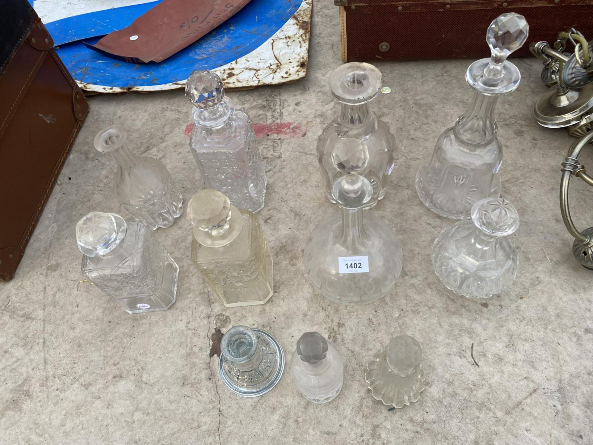 AN ASSORTMENT OF GLASS WARE TO INCLUDE DECANTORS AND A CANDLE HOLDER ETC