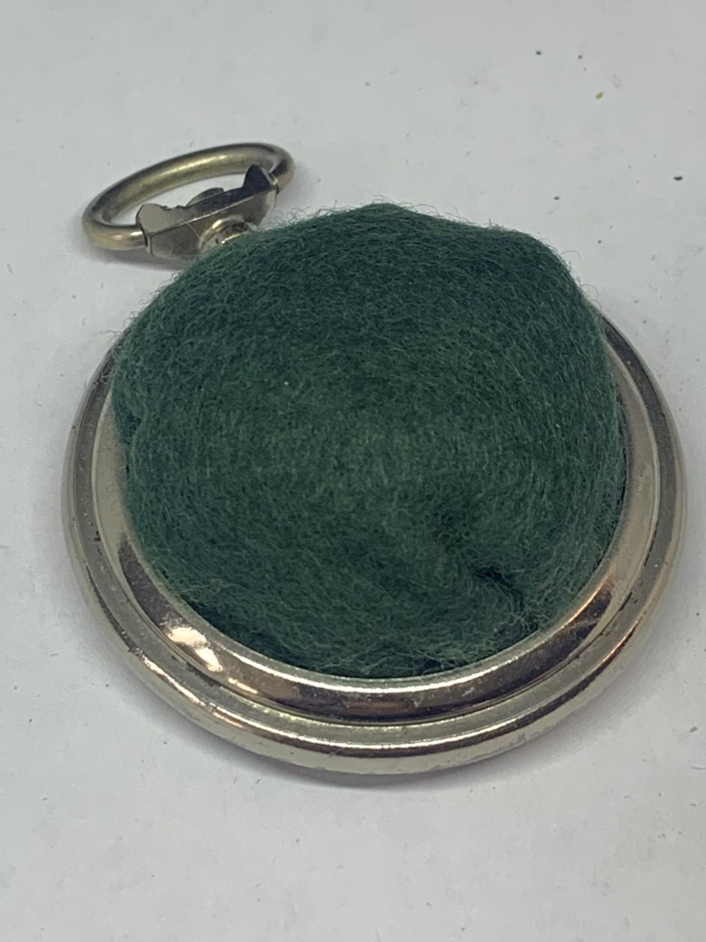 A POCKET WATCH STYLE PIN CUSHION