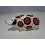 A ROYAL CROWN DERBY PIG PAPERWEIGHT WITH A SILVER STOPPER