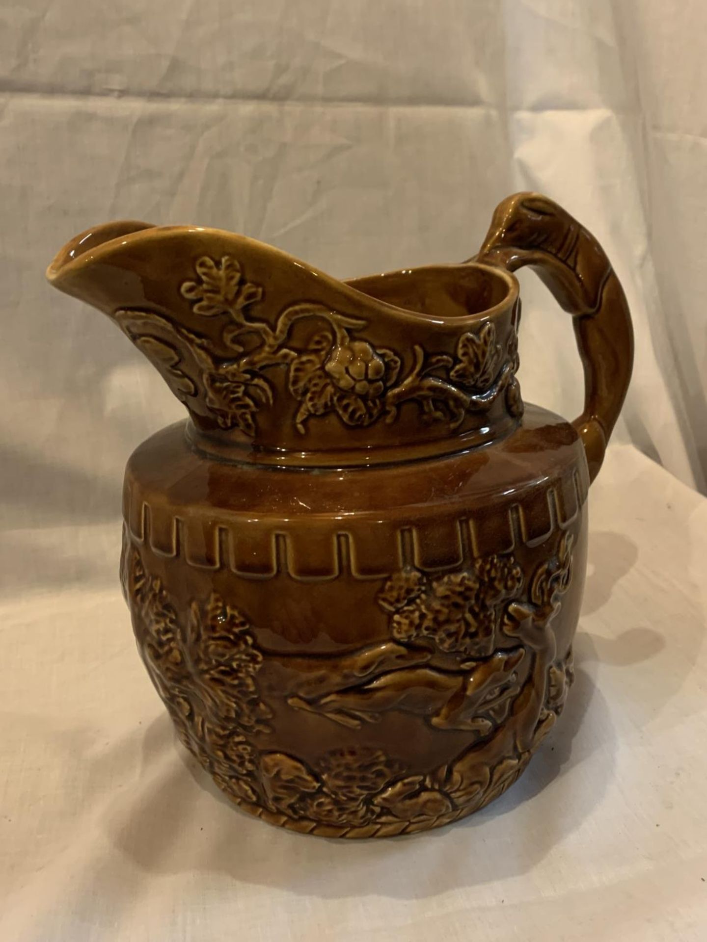 A WOOD LARGE TREACLE GLAZE JUG WITH BEAR AND HUNTING DECORATION AND A HOUND HANDLE - Image 2 of 5