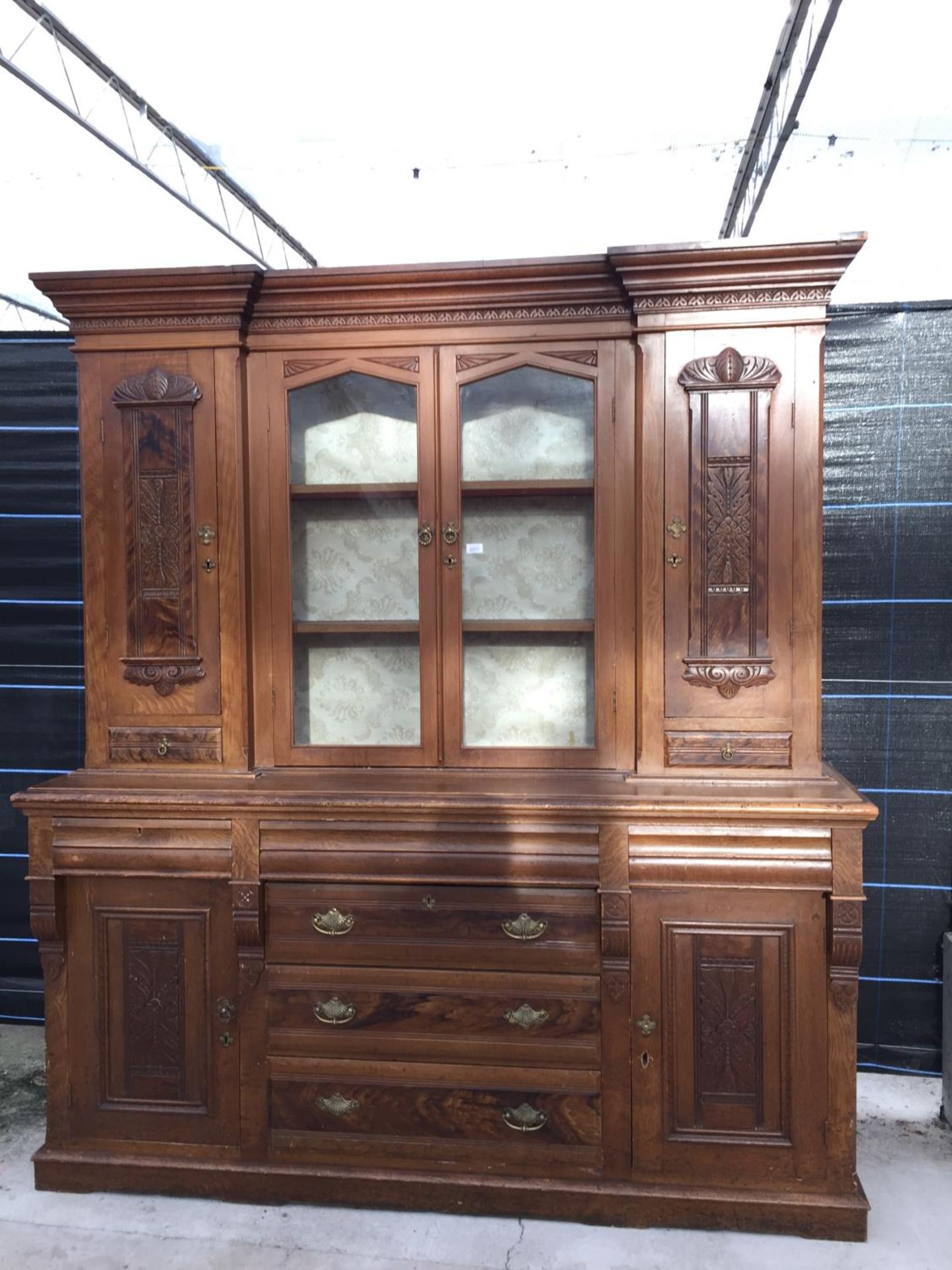 A VICTORIAN SCUMBLED PINE DRESSER, 74" WIDE, WITH INVERTED BREAKFRONT UPPER PORTION, HAVING PANELLED