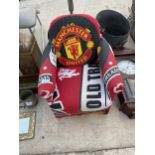 A SMALL CHILDRENS ARMCHAIR WITH MANCHESTER UNITED COVER