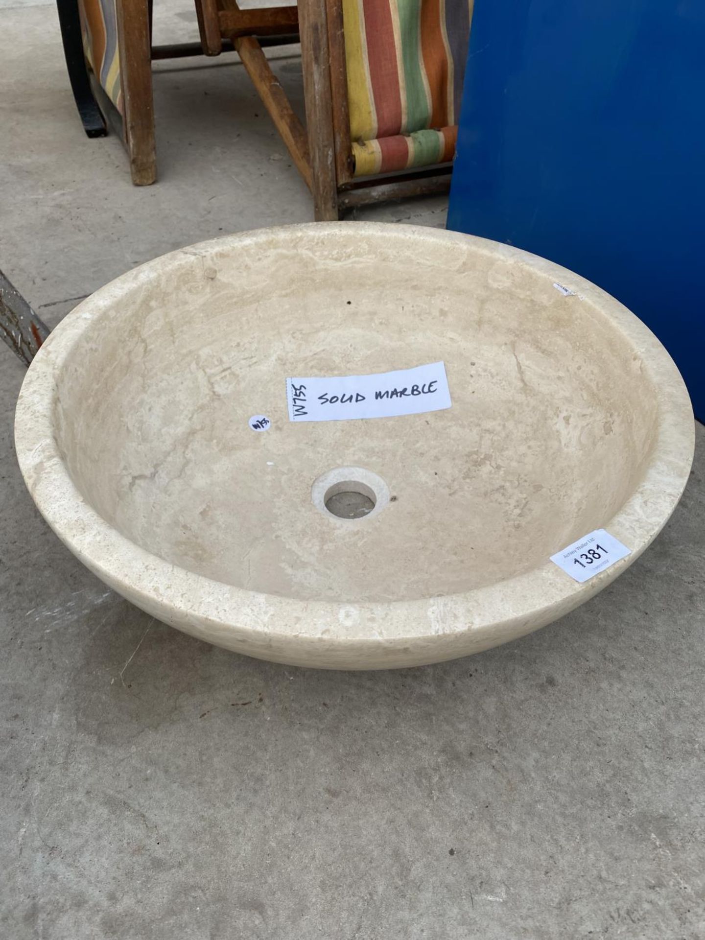 A CREAM WASH BASIN FORMED FROM A PIECE OF MARBLE