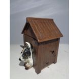 A CROWN DEVON MUSICAL DOG HOUSE CIGARETTE DISPENSOR