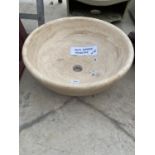 A CREAM WASH BASIN FORMED FROM A SOLID PIECE OF MARBLE