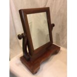 A SMALL WOODEN VANITY MIRROR