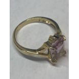 A 9 CARAT GOLD MARKED 375 RING WITH A LARGE PALE PURPLE COLOURED SQUARE STONE AND TWIST SHOULDERS