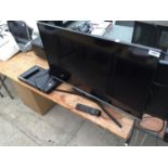 A 32" SAMSUNG TELEVISION AND REMOTE CONTROL