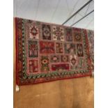 A LARGE RED AND GREEN PATTERNED RUG