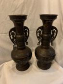 A PAIR OF TALL ORNATE BRONZE EFFECT VASES HEIGHT 46 CM