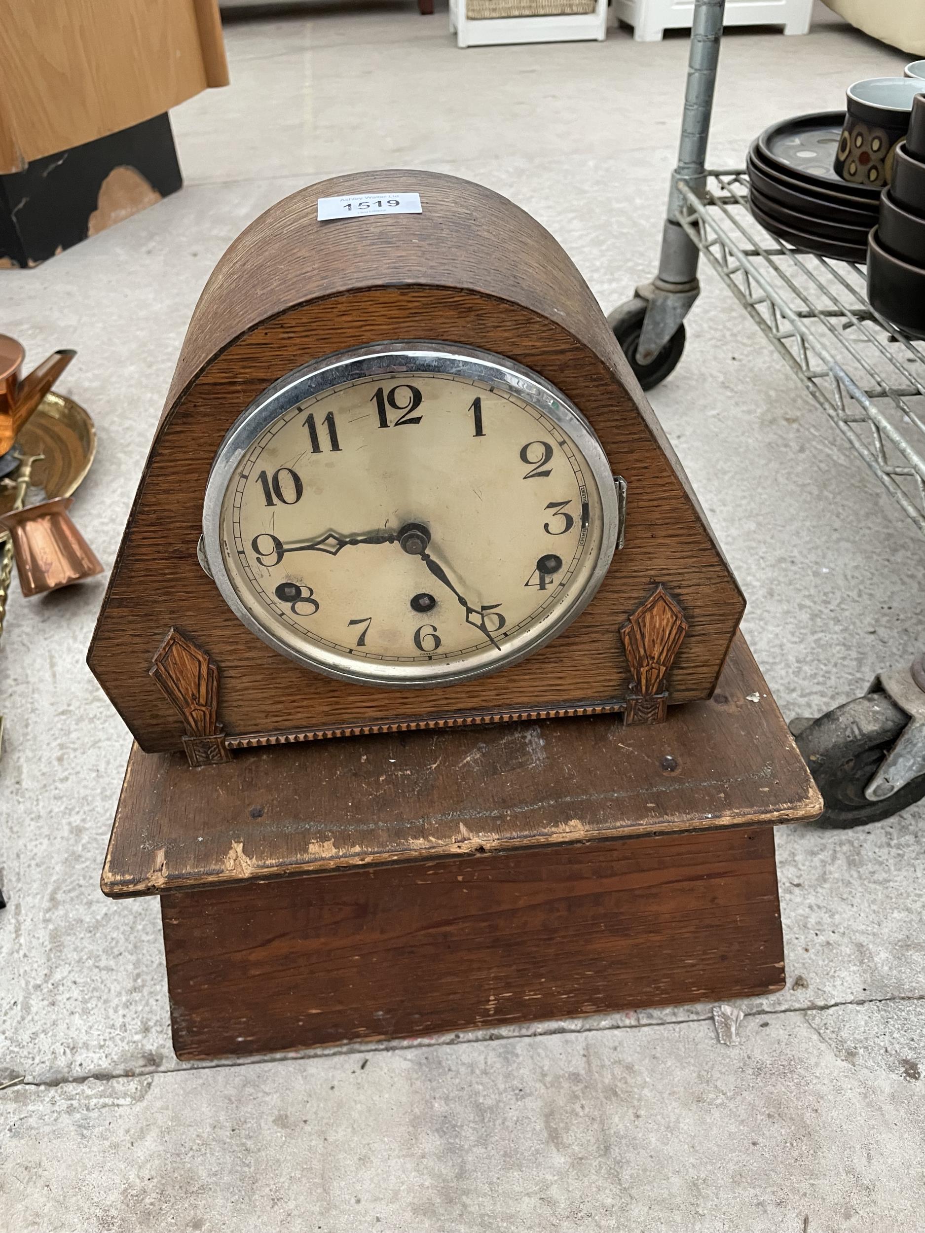 A WOODEN CASED MANTEL CLOCK WITH WOODEN PEDASTEL BASE