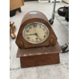 A WOODEN CASED MANTEL CLOCK WITH WOODEN PEDASTEL BASE