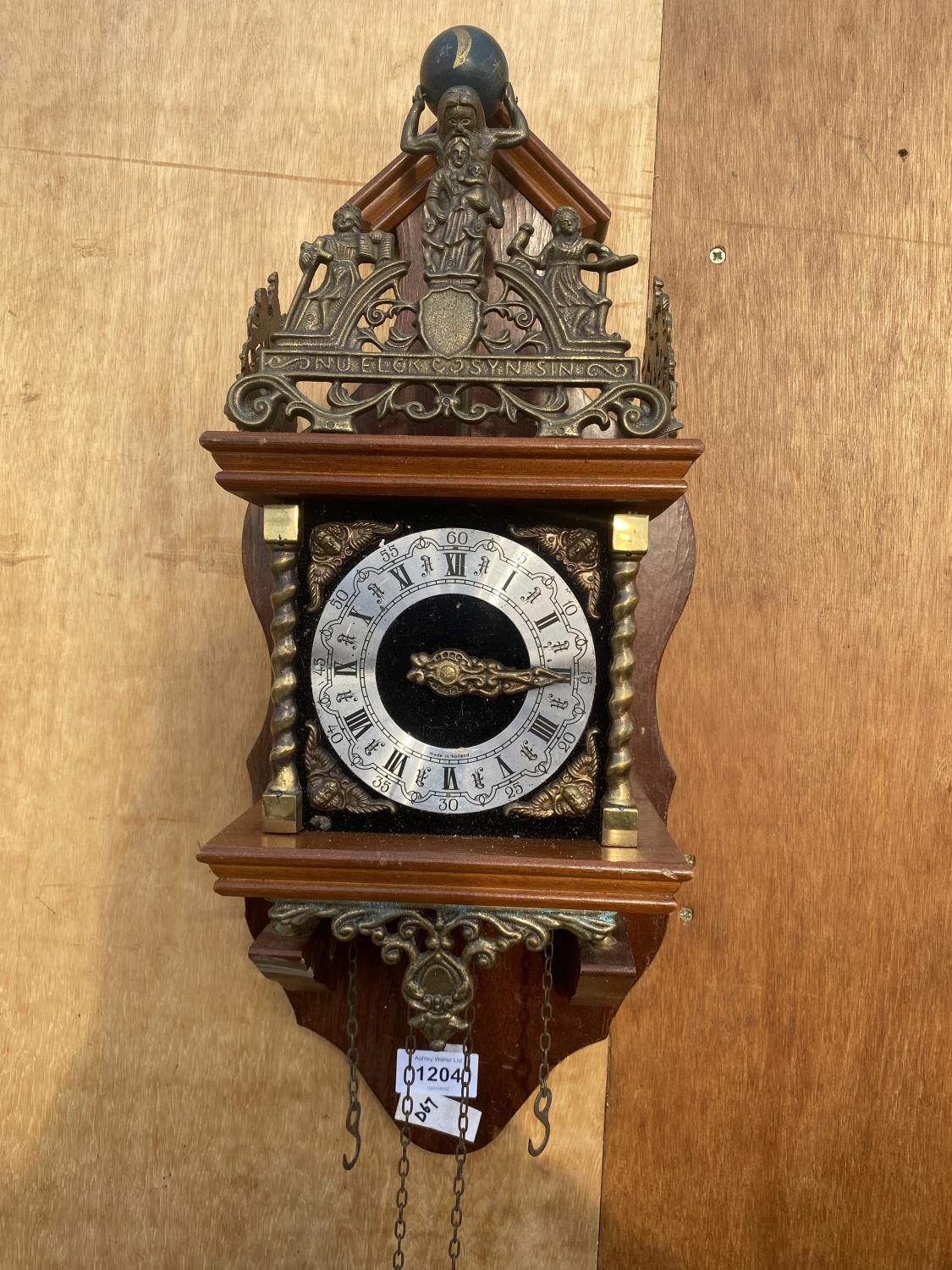 A VINTAGE WOODEN WALL CLOCK WITH BRASS DETAIL, STAMPED MADE IN HOLLAND