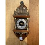 A VINTAGE WOODEN WALL CLOCK WITH BRASS DETAIL, STAMPED MADE IN HOLLAND