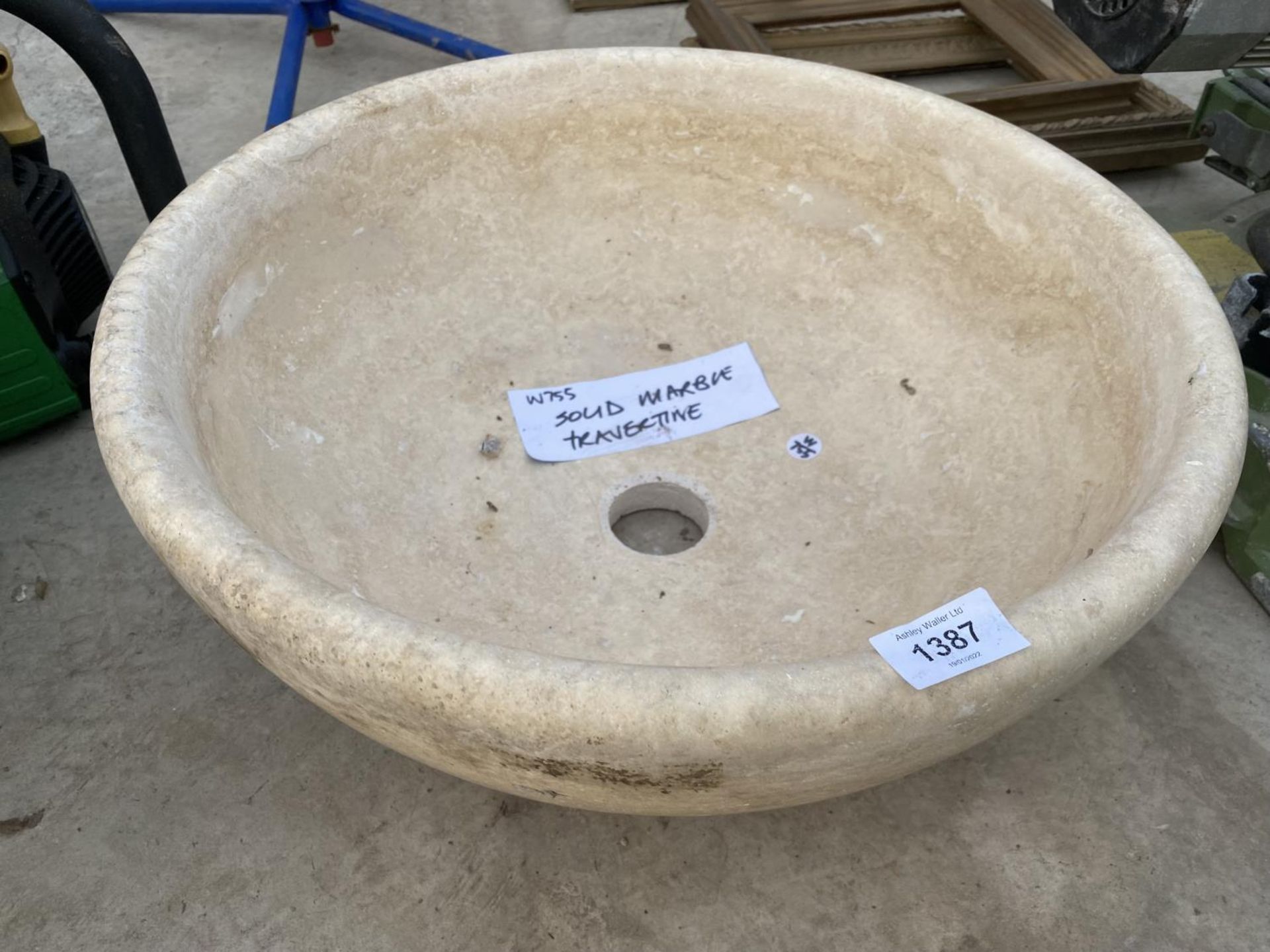 A CREAM WASH BASIN FORMED FROM A PIECE OF MARBLE