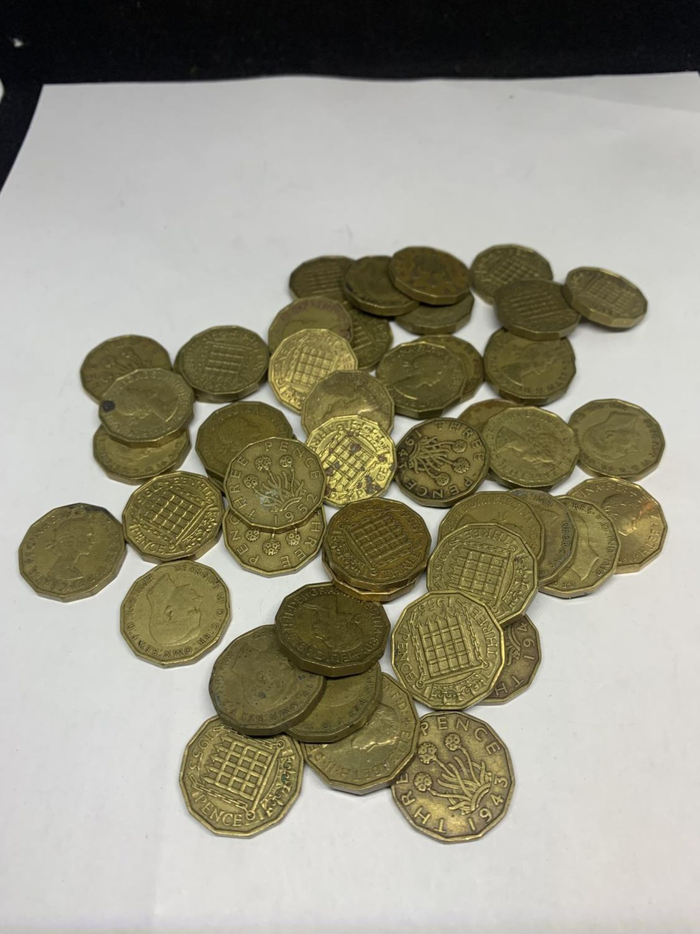 A LARGE QUANTITY OF THREE PENCE PIECES