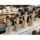 FOUR STONE EFFECT FIGURINES OF GOLD AND CREAM COLOURED LADIES