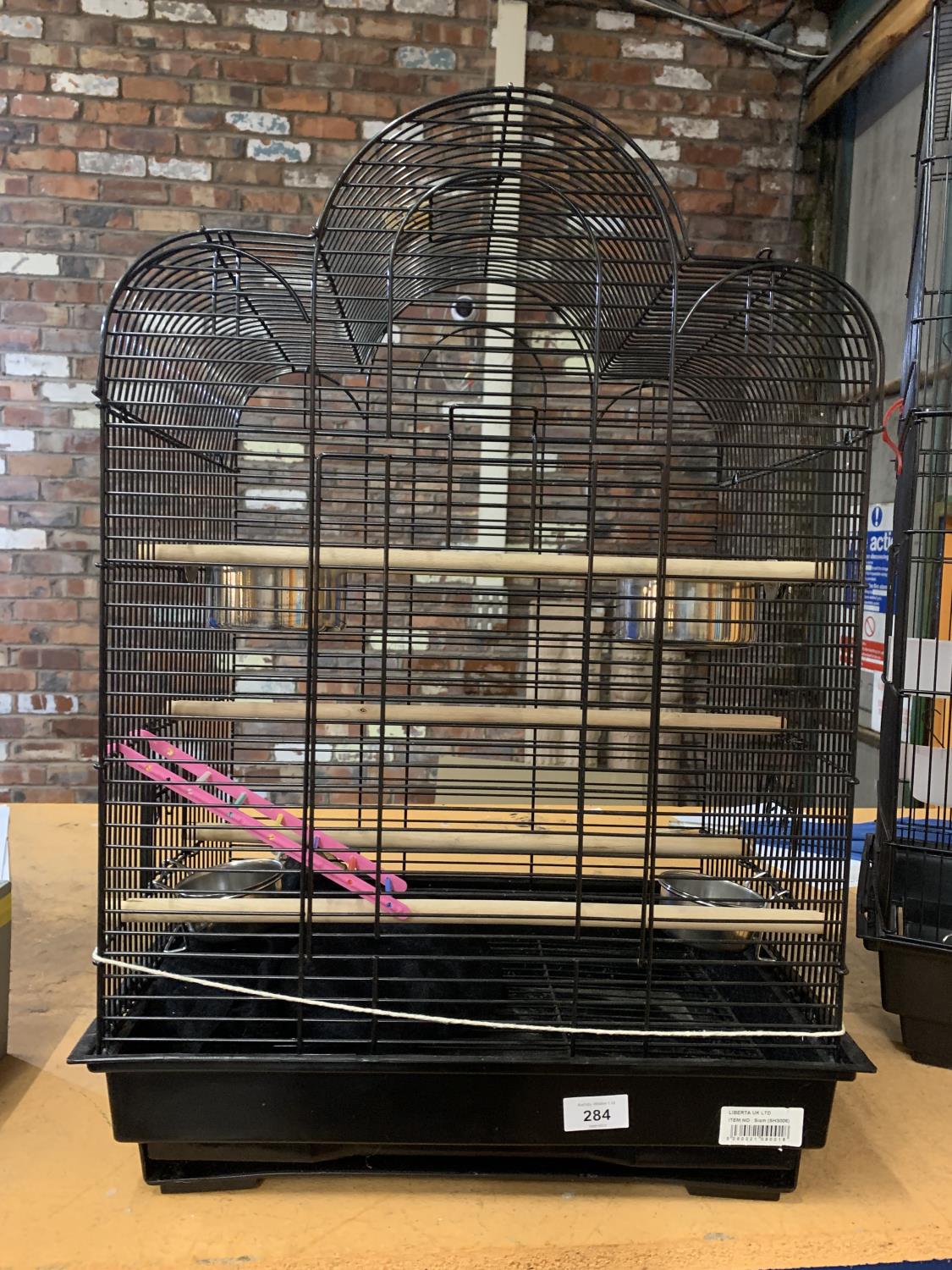 A LARGE BUDGIE CAGE WITH BOWLS AND PERCHES IN CLEAN CONDITION