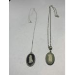 TWO OVAL SILVER WEDGWOOD JASPERWARE PENDANTS ONE BLACK AND ONE GREEN ON CHAINS