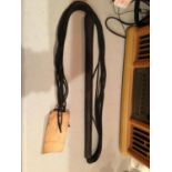 A WOODEN HANDLED WHIP
