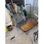 A LARGE ASSORTMENT OF GARDEN ITEMS TO INCLUDE A WHEEL BARROW, A SHELVING UNIT AND VARIOUS TOOLS ETC