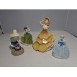 FOUR CERAMIC FIGURES TO INCLUDE A WADE, TWO ROYAL DOULTON AND A COALPORT