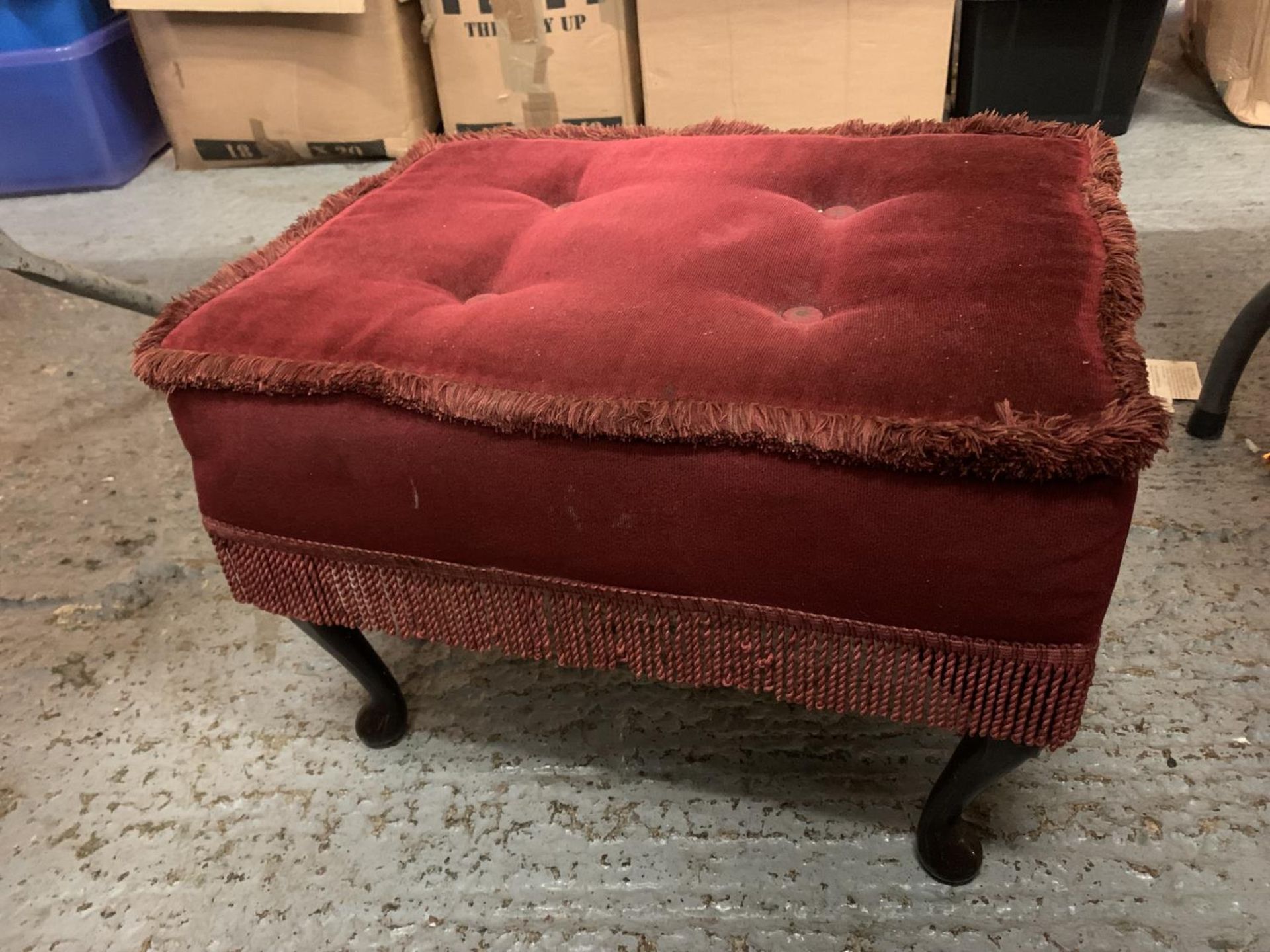 A VINTAGE FOOTSTOOL WITH RED VELVET UPHOLSTERY