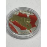 A SILVER 2017 1OZ CANADIAN FIVE DOLLAR COIN WITH RED AND GILDED LYNX DECORATION CAPSULATED