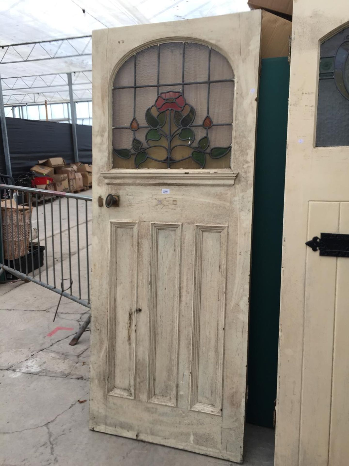 AN EARLY 20TH CENTURY COLOURED GLASS AND LEADED DOOR 31.5" WIDE