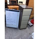 A WHITE BOARD WITH STAND AND A FOUR DRAWER METAL FILING CABINET