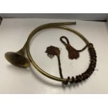 A BRASS COILED HUNTING HORN