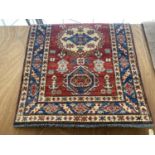 AN AS NEW RED PATTERNED PERSIAN STYLE HANDKNOTTED RUG BEARING THE LABEL OF PERSIAN RUGS DIRECT