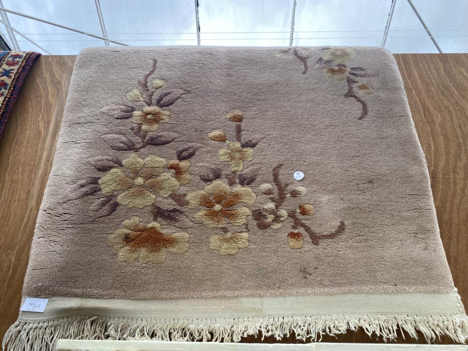 A SMALL CREAM PATTERNED RUG