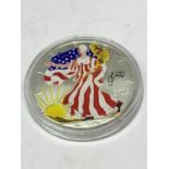 A SILVER 2008 1OZ AMERICAN ONE DOLLAR COIN WITH A COLOURED LIBERTY EAGLE DECORATION -CAPSULATED