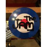 A ROUND METAL SIGN 'THE JAM'