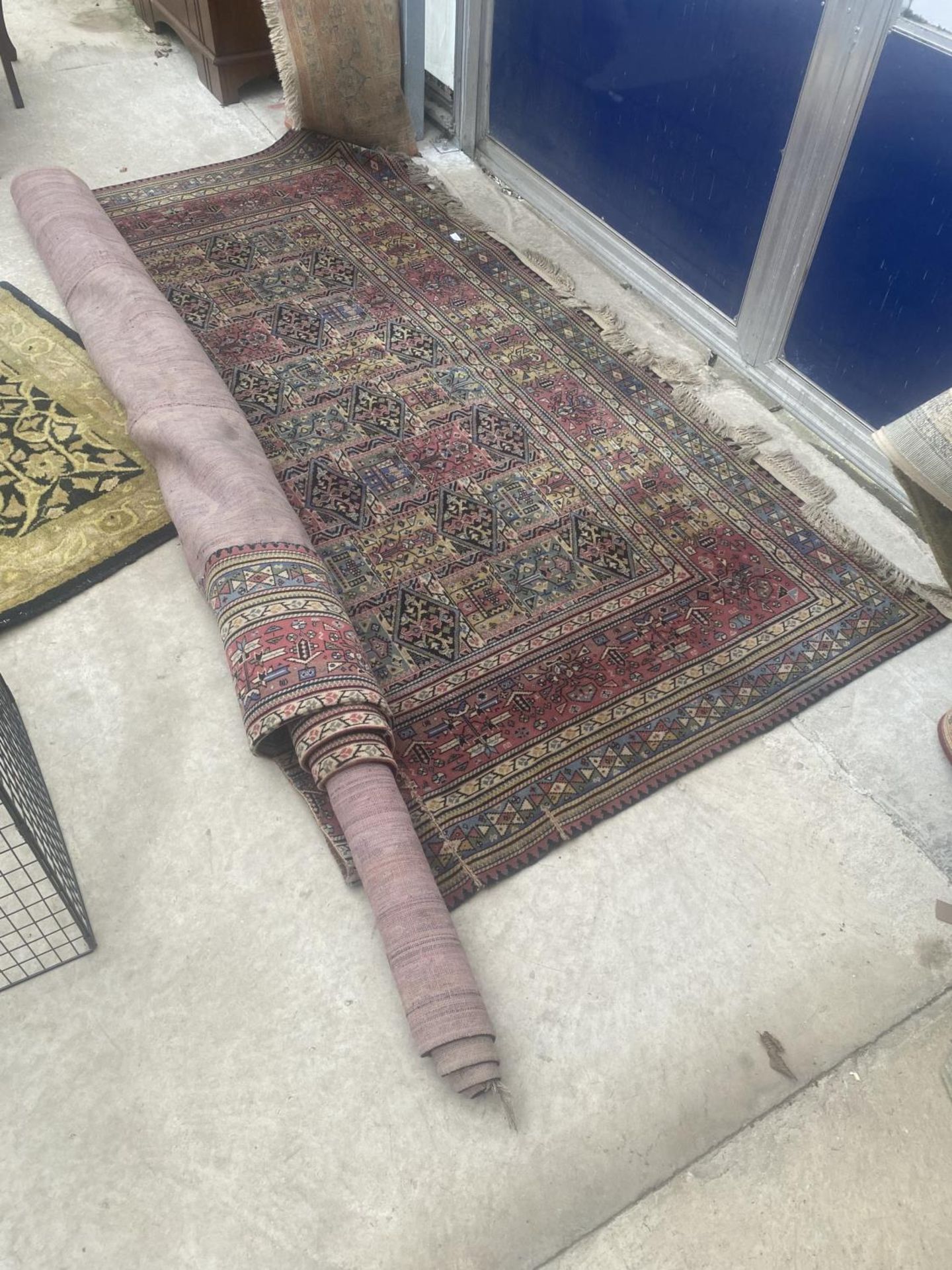 A LARGE RED PATTERNED RUG