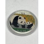 A SILVER 2011 1OZ COIN AG .999 WITH PANDA AND CUB DECORATION CAPSULATED