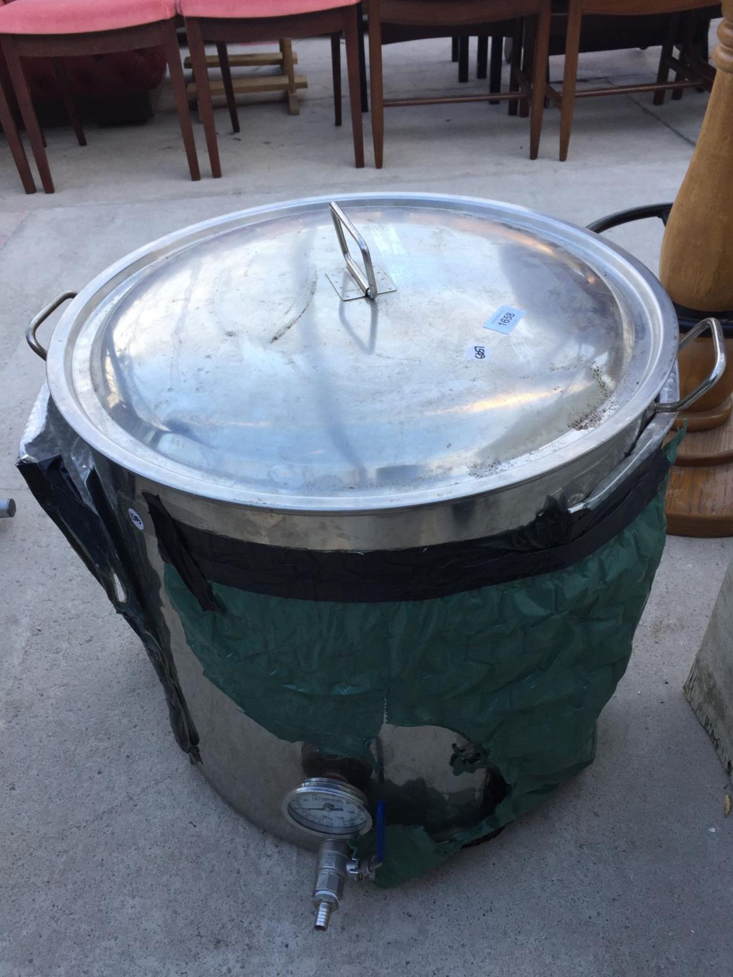 A LARGE STAINLESS STEEL COOKING POT