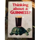 A METAL SIGN ADVERTISING GUINNESS