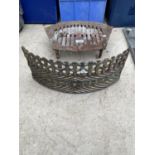 A VINTAGE CAST IRON FIRE GRATE AND FIRE FRONT
